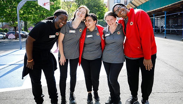 Group of five 黄色视频 AmeriCorps members arm in arm smiling at the camera